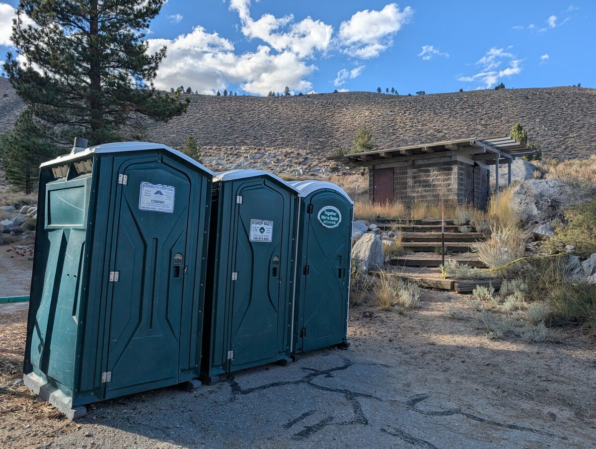 Interior view of one of the portable toilets, showing it is clean and stocked.